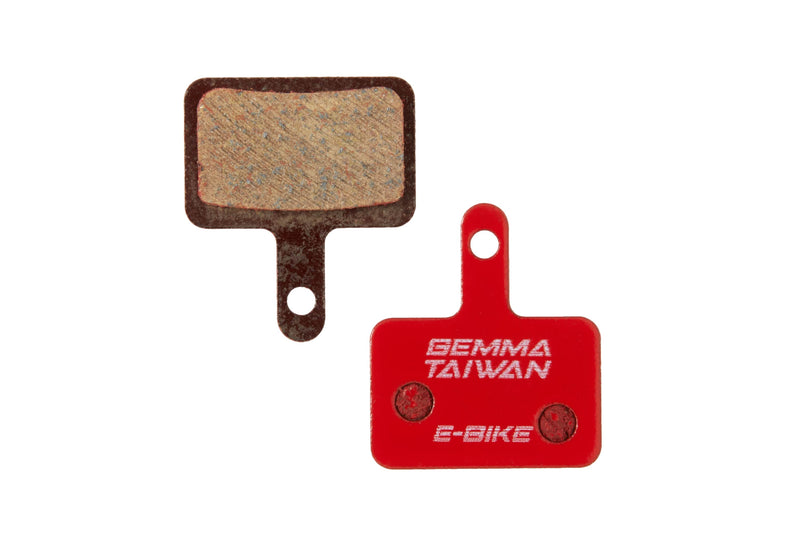 Front and back of the Gemma, G2, Semi-metallic brake pads. The back of the pad is bright red and has "Gemma Taiwan E-bike" stamped on it.