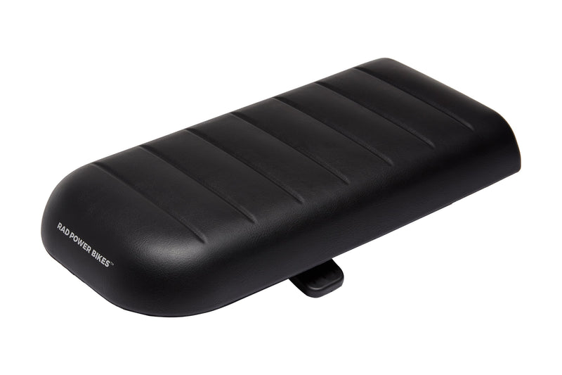 RadWagon deckpad, used for passenger seating on a RadWagon electric cargo bike. Black vinyl material with padding. Subtle Rad Power Bikes logo along the end.