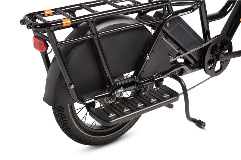 RadWagon Running Boards shown installed on the right side of a RadWagon 5 electric cargo bike. Cast aluminum foot boards that attach to the ebike and allow a passenger to rest their feet.